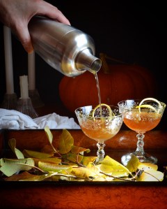 cocktail made with rum and apple cider being poured into a glass