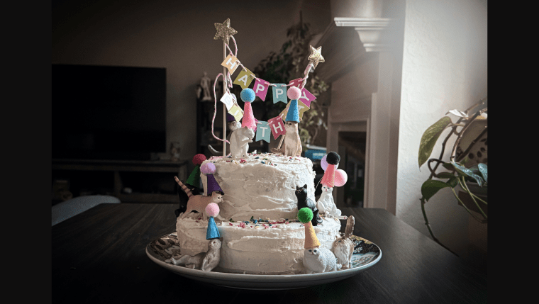 Four layer chocolate cake with vanilla buttercream frosting and cat decorations