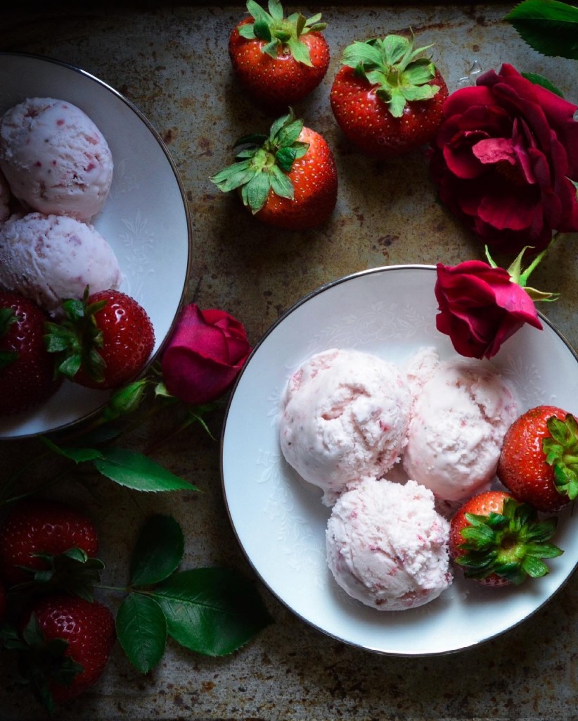 Homemade strawberry ice cream with red roses and fresh strawberries